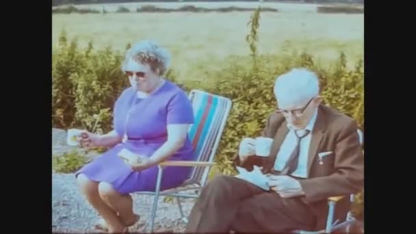United Kingdom 1966, English people drink tea in garden — стоковое видео
