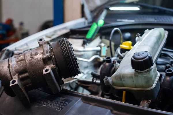 Automobile engine with disassembled parts in a Workshop