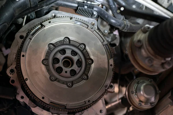 Detail of Car flywheel assembly in a workshop, car reparation engine