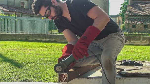 Worker Angle Grinder Cuts Iron Profile Construction Site — Stock Video