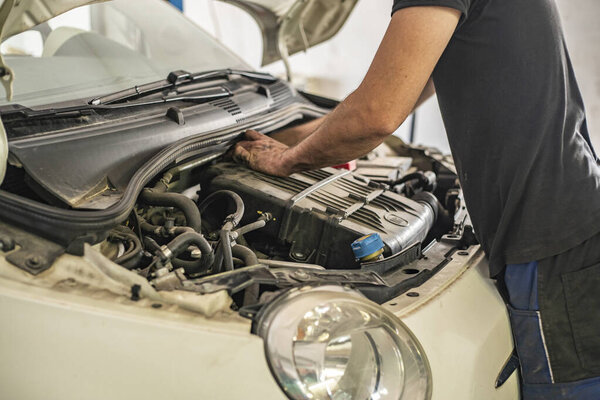MILAN, ITALY 14 JULY 2021: Mechanic repair Detail of Engine powered by methane in a workshop