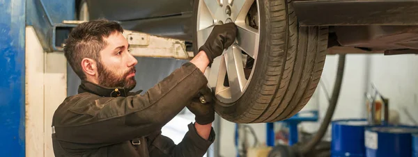 Mechanic repairs car, banner image with copy space