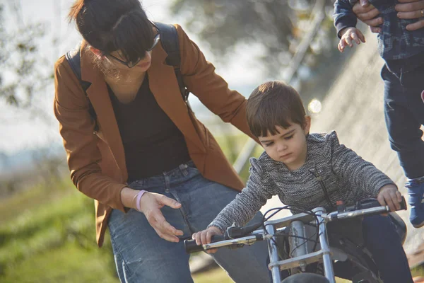 Close up Portrait of Mom teaches the child to ride a bike