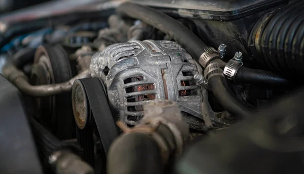 Car engine alternator detail in a mechanical workshop