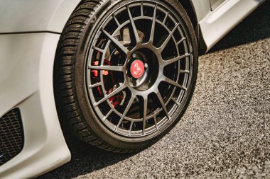 Rome, italy 10 september 2025: abarth alloy wheel and performance brake caliper close-up showcasing precision engineering, sporty design and high-quality finish
