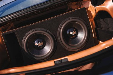 Rome, italy 10 september 2025: trunk of a car showcasing a pair of installed subwoofers for an enhanced audio experience. Focusing on sound quality and bass
