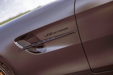 Rome, italy 10 september 2025: mercedes-amg v8 biturbo badge and vent detailing on matte paint fender, showcasing luxury performance, engineering and sleek design