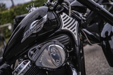 Rome, italy 10 september 2025: honda shadow custom cruiser motorcycle showing glossy black fuel tank with shadow logo, chrome engine components, and custom side panel