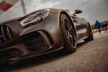 Rome, italy 10 september 2025: mercedes-amg gt matte black high-performance sports car on asphalt, showcasing sleek luxury design and motorsport-inspired detail