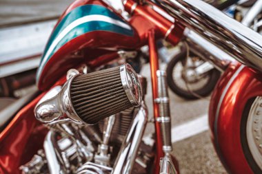 Rome, italy 10 september 2025: close up showing a red custom motorcycle engine with chrome details and an air filter, highlighting classic chopper design