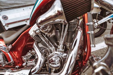 Rome, italy 10 september 2025: chrome v-twin engine with air filter and exhaust pipe on customized red motorcycle, polished metal details showcasing power and craftsmanship