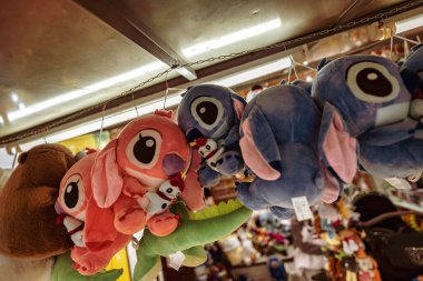 Rome, italy 10 september 2025: plush prizes hanging at a colorful carnival stall, evoking childhood joy, fairground fun, and playful souvenir shopping