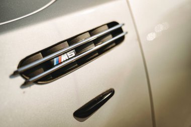 Rome, italy 10 september 2025: bmw m5 fender vent and badge close-up showcasing luxury performance design, sleek metallic detail, emblematic german engineering excellence