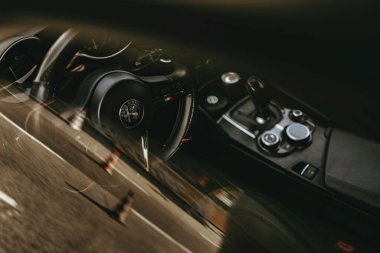 Rome, italy 10 september 2025: alfa romeo cockpit in motion, blurred highway ahead conveying high-speed luxury, modern dashboard, steering wheel and dynamic driving energy