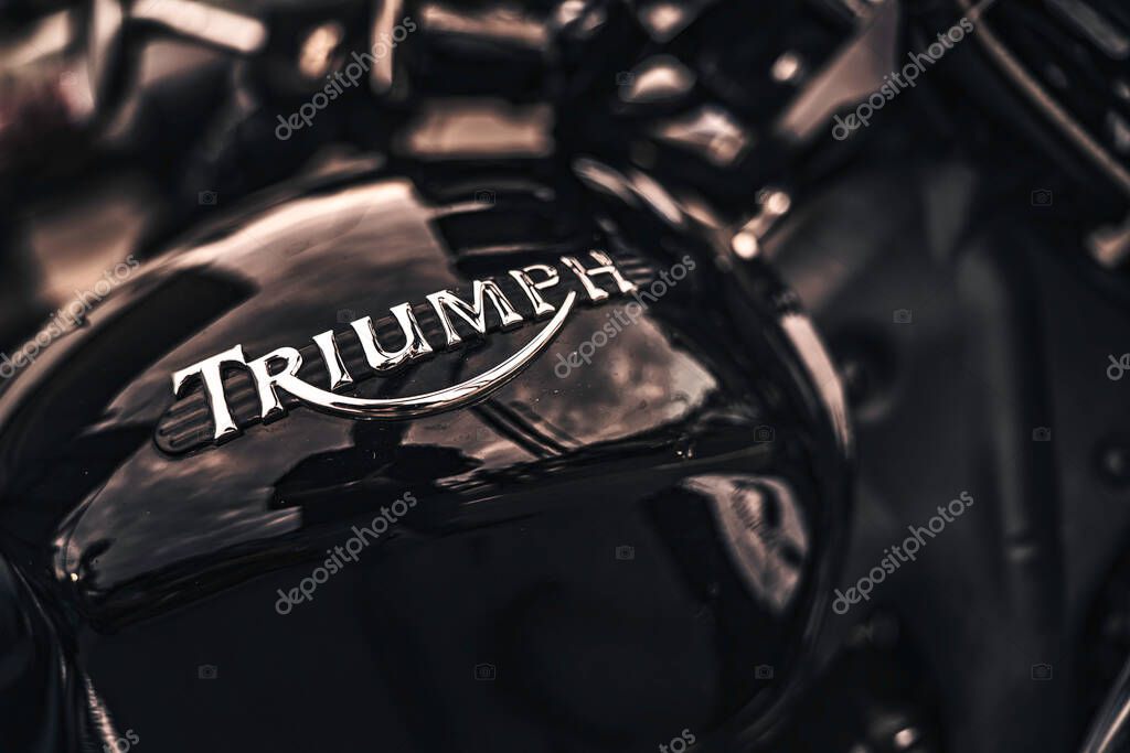Rome, italy 10 september 2025: triumph motorcycle fuel tank with iconic chrome logo and glossy reflection, classic vintage design conveying power, style, and heritage