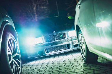 Este, İtalya 28 Ekim 2025: BMW gece parlayan farlar, agresif ızgara ve düşük açılı ön manzara özel ayarlama ve şık duruş ile park