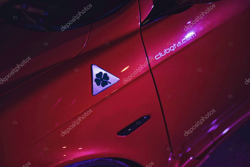 Este, italy 28 october 2025: alfa romeo quadrifoglio emblem adorning a red car's side, highlighting performance and automotive design with clubgta.Com detail
