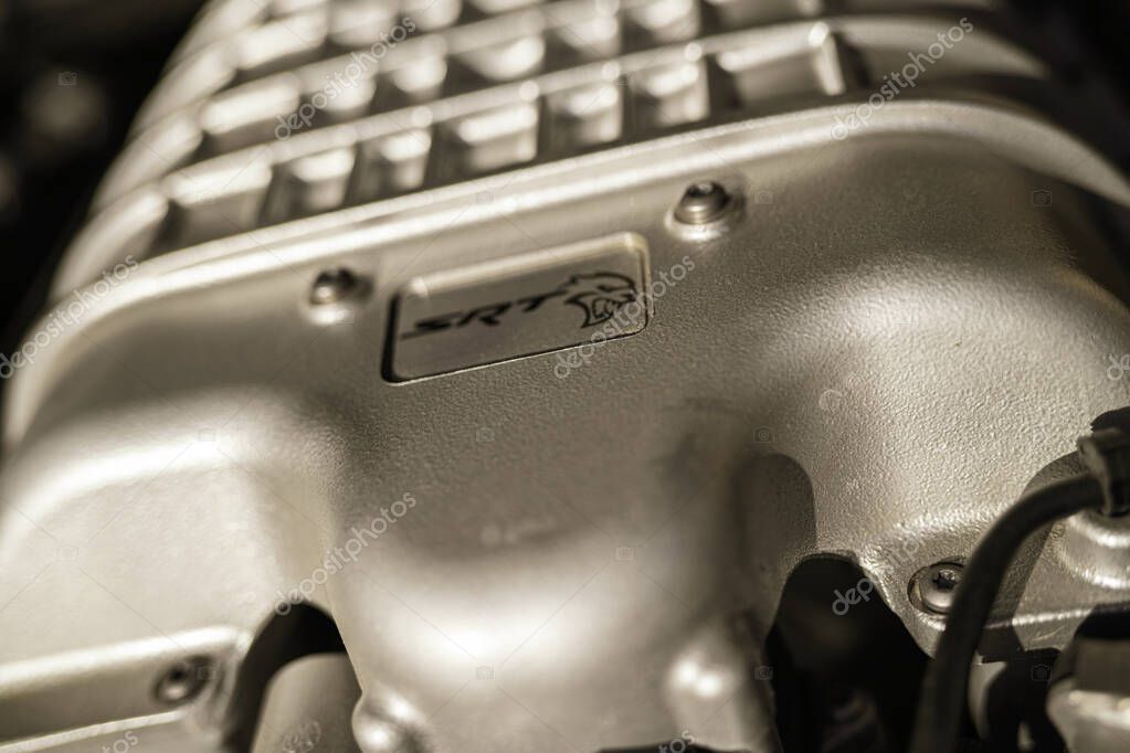 Milan, italy 28 october 2025: dodge hellcat supercharger close-up with srt logo, v8 performance engineering detail showcasing raw power and chrome muscle-car craftsmanship