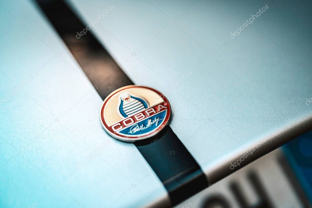 Milan, italy 28 october 2025: shelby cobra car emblem featuring a cobra icon on a vintage vehicle with racing stripes, representing speed and performance