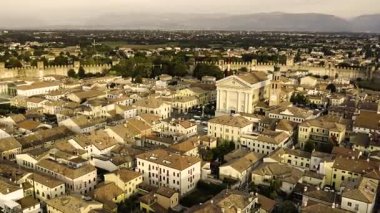 Bassano del grappa, italy 20 november 2025: aerial footage of bassano del grappa city, revealing its beautiful architecture, the brenta river, and surrounding green mountains