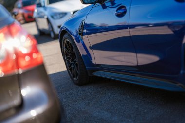 Imola, İtalya 01 Ocak 2026: mavi spor araba tarafı ve asfalta parkedilmiş krom tekerlek, parlak metalik kaplama, modern tasarım ve performans cazibesi