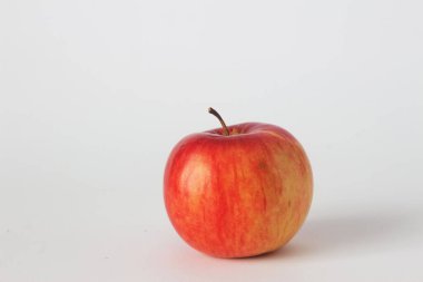 Beyaz arkaplanda tek kırmızı olgun elma