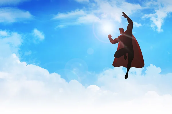 Silhouette einer Superheldenfigur, die auf Wolken fliegt — Stockfoto