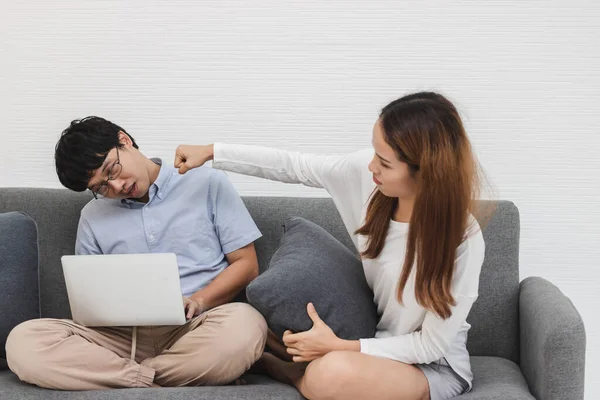 Annoyed young Asian couple fighting in living room after conflict quarrel. Mistrust and cheat problems.