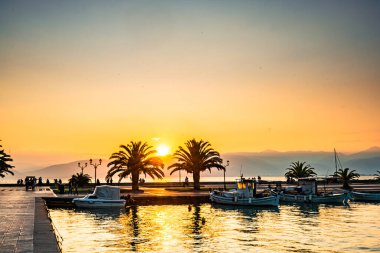 Sunset in the harbor of Nafplio, Greece clipart