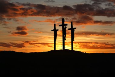 Three crosses over bright sunset with copy space clipart