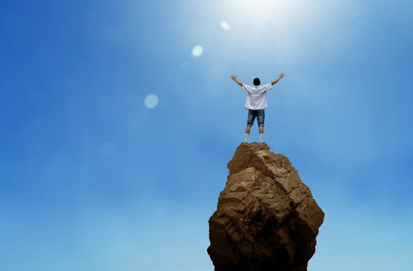 Cheering man open arms on mountain peak cliff — Stock Photo, Image