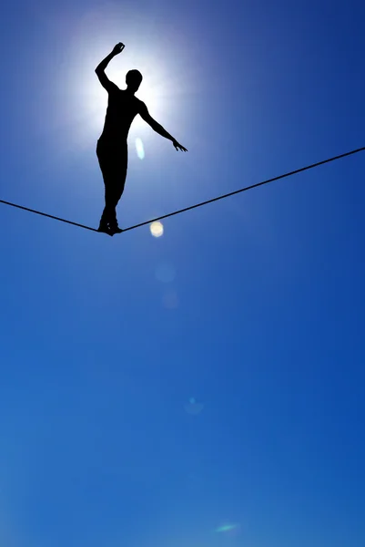 Silhouette of man on the rope concept of risk taking and challen — Stock Photo, Image