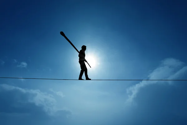 Concept of risk taking and challenge highline walker in blue sky — Stock Photo, Image