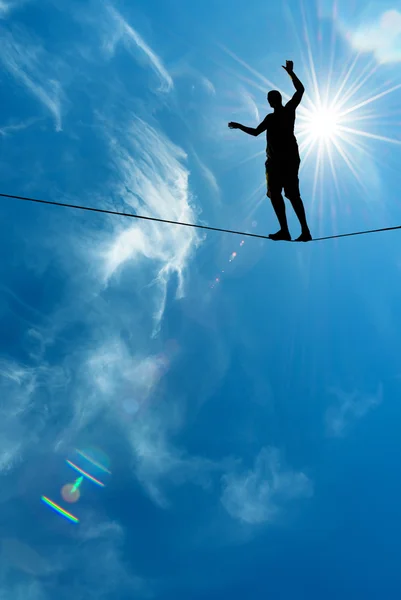 Silhouette of man on the rope concept of risk taking and challen — Stock Photo, Image