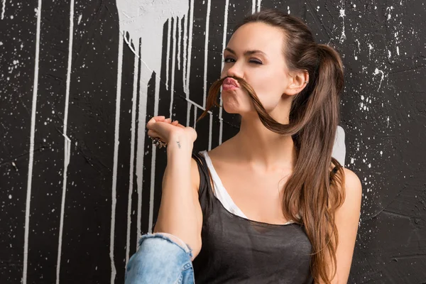 Funny girl showing mustache from the hair — Stock Photo, Image