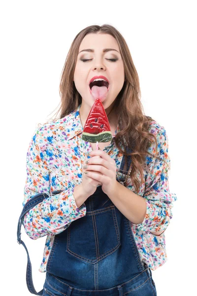 Young cheerful woman sucks lollipop — Stock Photo, Image