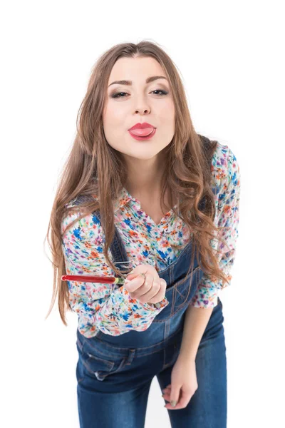 Beautiful girl posing in studio and showing tongue — Stock Photo, Image