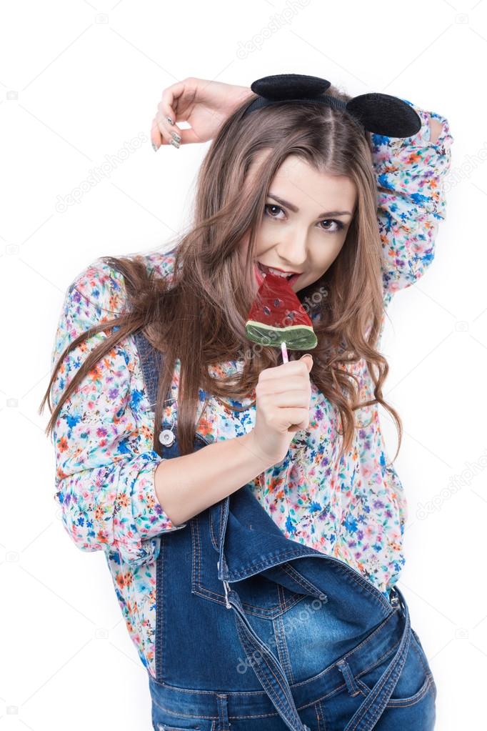 Young cheerful woman  sucks lollipop