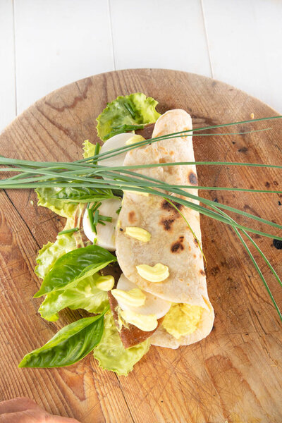 Vegan cuisine presentation of a flatbread made entirely of vegetable foods prepared mayonnaise salad and vegetable cheese 