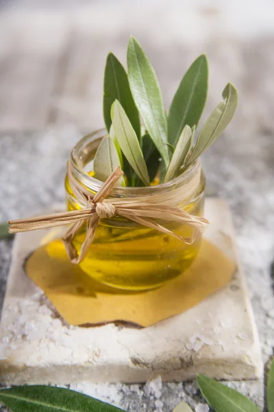 Small glass jar containing olive oil — Stock Photo, Image