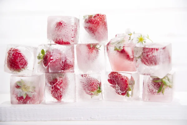 Ice cubes with strawberries — Stock Photo, Image