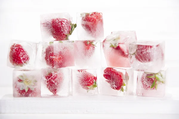 Ice cubes with strawberries — Stock Photo, Image