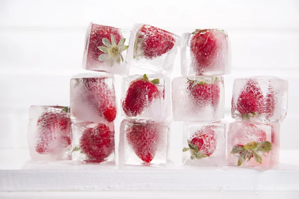 Ice cubes with strawberries — Stock Photo, Image