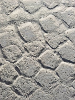 Tozlu zemine kazınmış lastik izlerinin yakın çekimi, özgeçmiş, ayak izi analizi ve teknik görselleştirme projeleri için ideal detaylı bir doku.. 