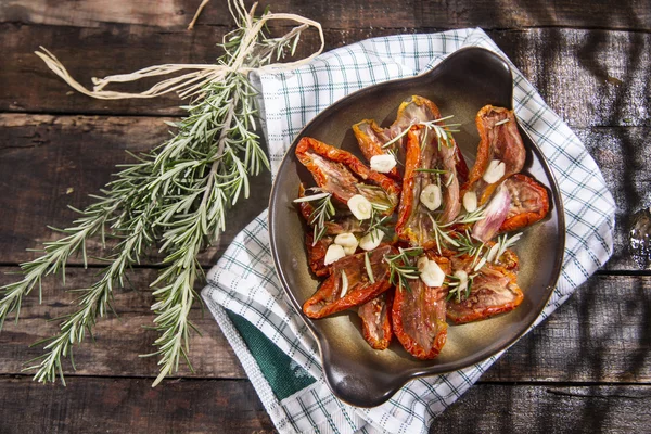 Dried tomatoes and rosemary — Stock Photo, Image