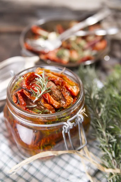 Dried tomatoes and rosemary — Stock Photo, Image