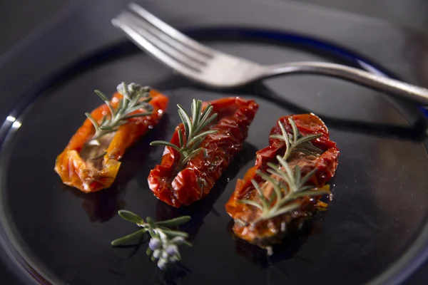 Dried tomatoes with rosemary — Stock Photo, Image