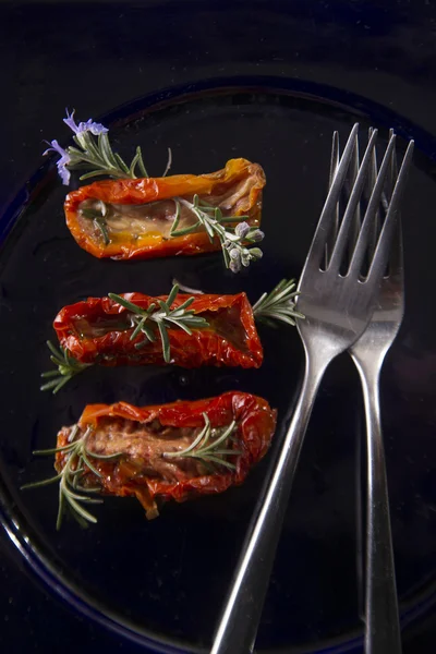 Dried tomatoes with rosemary — Stock Photo, Image