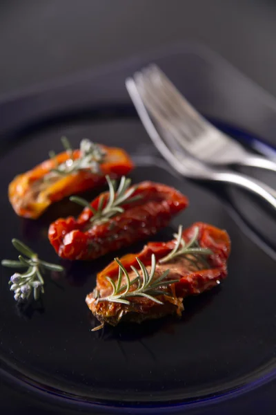 Dried tomatoes with rosemary — Stock Photo, Image