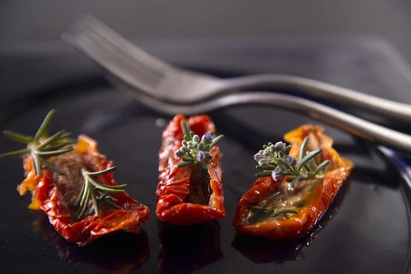 Dried tomatoes with rosemary — Stock Photo, Image
